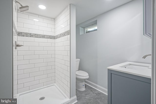 bathroom with toilet, a stall shower, marble finish floors, and baseboards