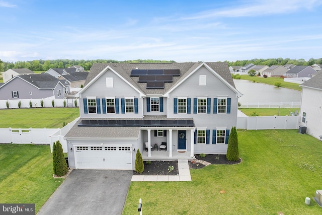 9508 Mourning Dove Way, Delmar, MD 21875 - traditional-style home with asphalt driveway, a residential view, roof with shingles, roof mounted solar panels, and a porch
