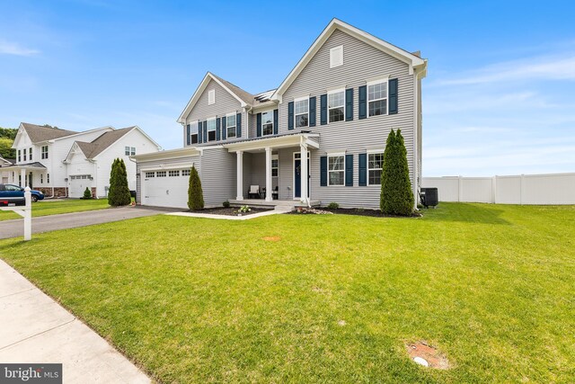 9508 Mourning Dove Way, Delmar, MD 21875 - view of front facade with asphalt driveway, covered porch, central air condition unit, and an attached garage