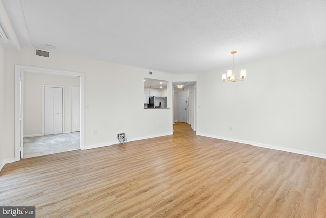 24 Courthouse Sq Unit 710, Rockville, MD 20850 - unfurnished living room with a chandelier, light wood-style floors, and baseboards