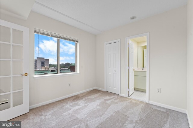 24 Courthouse Sq Unit 710, Rockville, MD 20850 - unfurnished bedroom with carpet flooring, baseboards, a closet, and ensuite bathroom