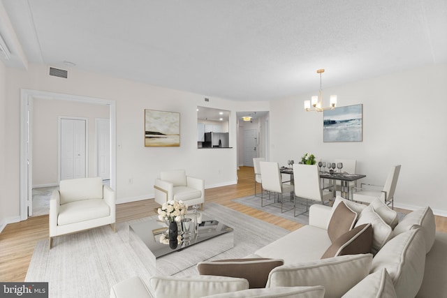 24 Courthouse Sq Unit 710, Rockville, MD 20850 - living area featuring a chandelier, light wood-type flooring, and baseboards