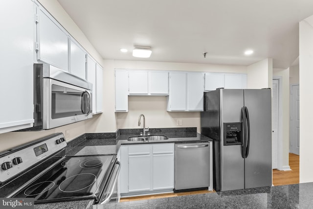 24 Courthouse Sq Unit 710, Rockville, MD 20850 - kitchen with appliances with stainless steel finishes, a sink, white cabinets, recessed lighting, and dark stone countertops