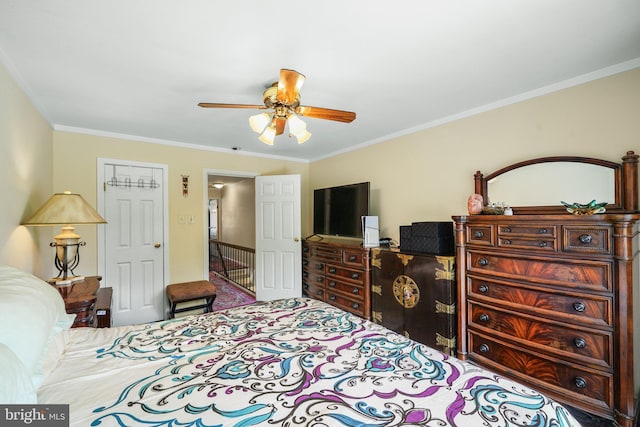 bedroom featuring ornamental molding, a ceiling fan, and carpet