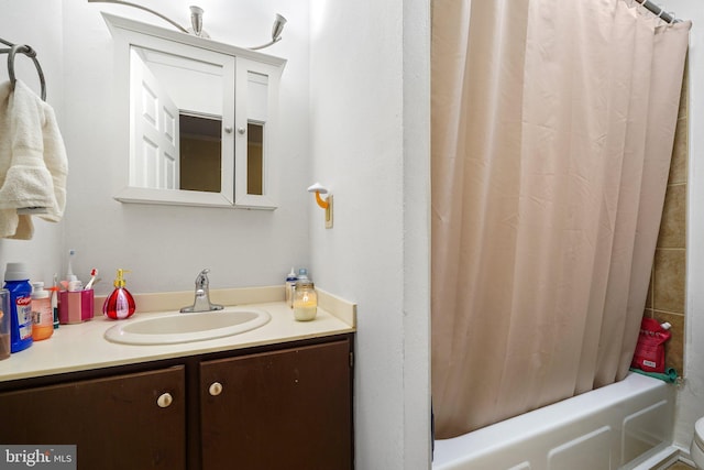 bathroom featuring vanity and shower / bath combo with shower curtain