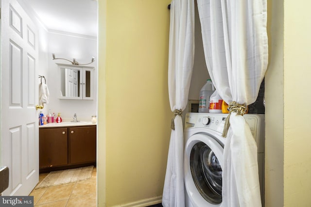 washroom with washer / clothes dryer and light tile patterned floors