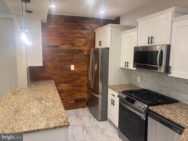 kitchen featuring appliances with stainless steel finishes, light stone countertops, white cabinets, light marble finish flooring, and recessed lighting