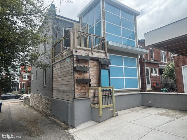 view of side of home with a balcony