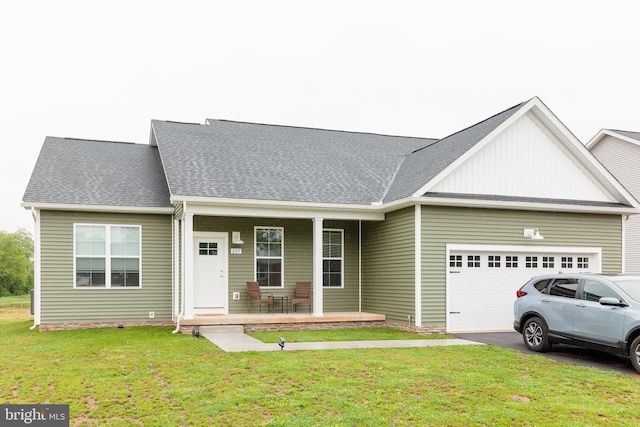 205 Kinneman Rd, Abbottstown, PA 17301 - view of front of home featuring a porch, an attached garage, a front lawn, board and batten siding, and driveway