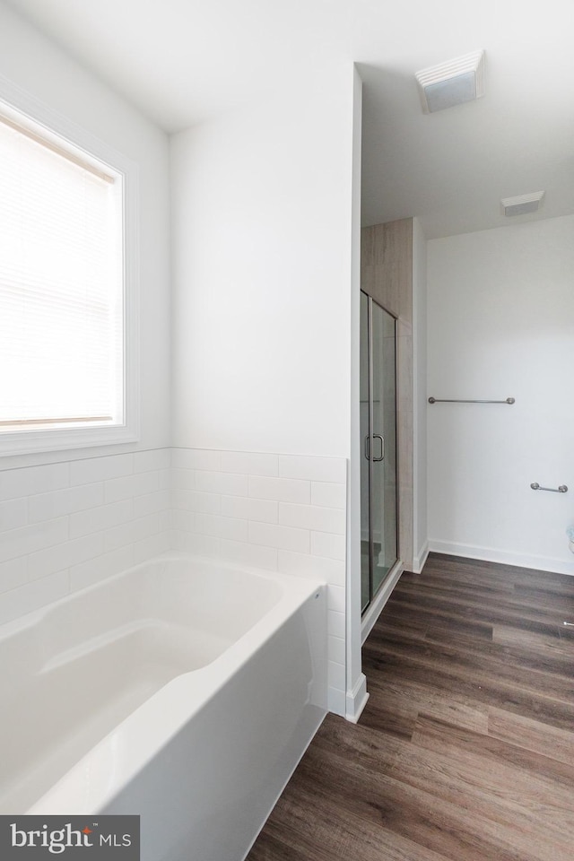 205 Kinneman Rd, Abbottstown, PA 17301 - bathroom with a bath, wood finished floors, a shower stall, and baseboards