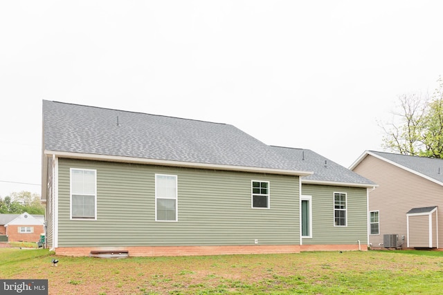 205 Kinneman Rd, Abbottstown, PA 17301 - back of property with central AC unit, a lawn, and a shingled roof