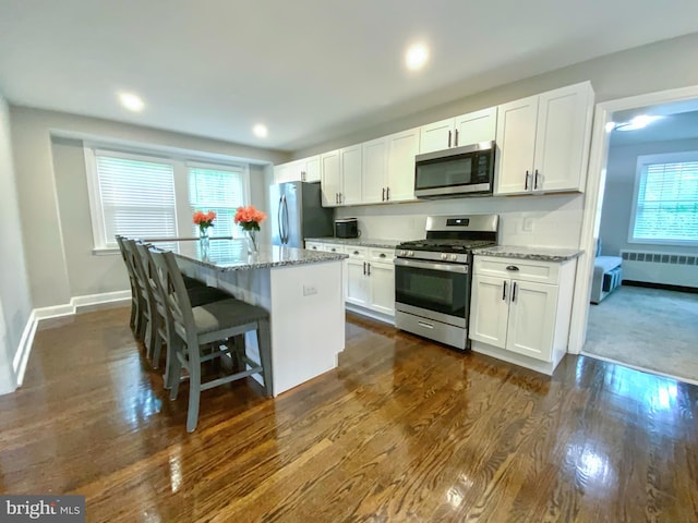 239 Glentay Ave, Lansdowne, PA 19050 - kitchen with appliances with stainless steel finishes, radiator, a kitchen island, white cabinetry, and recessed lighting