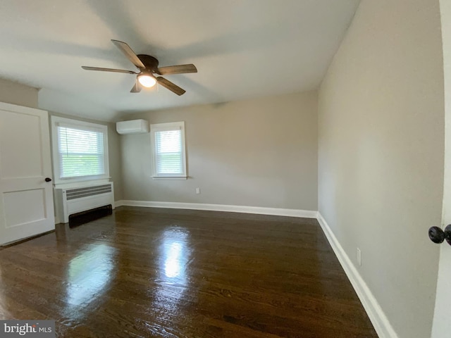 239 Glentay Ave, Lansdowne, PA 19050 - empty room featuring an AC wall unit, radiator, ceiling fan, wood finished floors, and baseboards