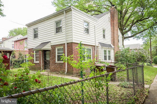 239 Glentay Ave, Lansdowne, PA 19050 - view of front facade with brick siding, a chimney, and a shingled roof