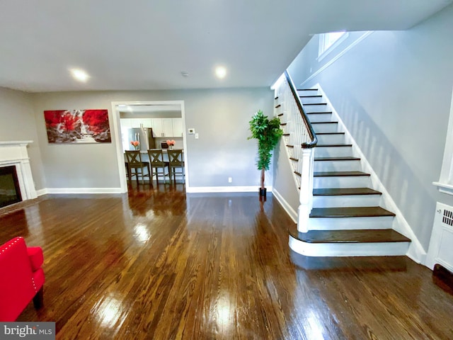 239 Glentay Ave, Lansdowne, PA 19050 - living room with stairs, wood finished floors, baseboards, and a glass covered fireplace