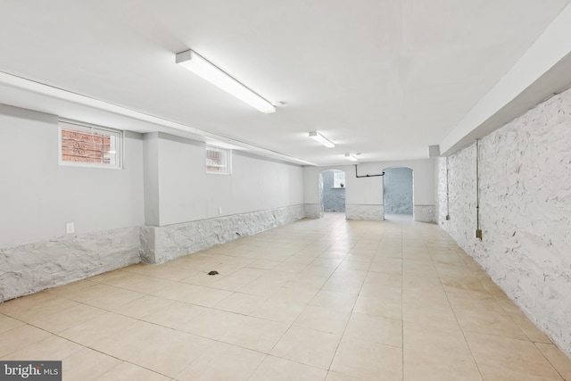 1609 N Hilton St, Baltimore, MD 21216 - below grade area featuring light tile patterned floors and arched walkways