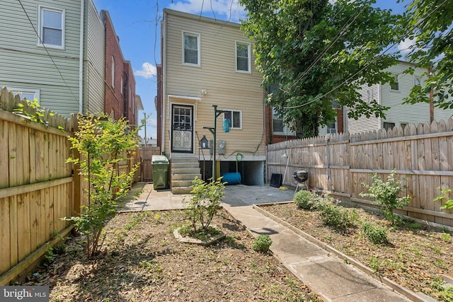 1609 N Hilton St, Baltimore, MD 21216 - back of property featuring a patio and a fenced backyard