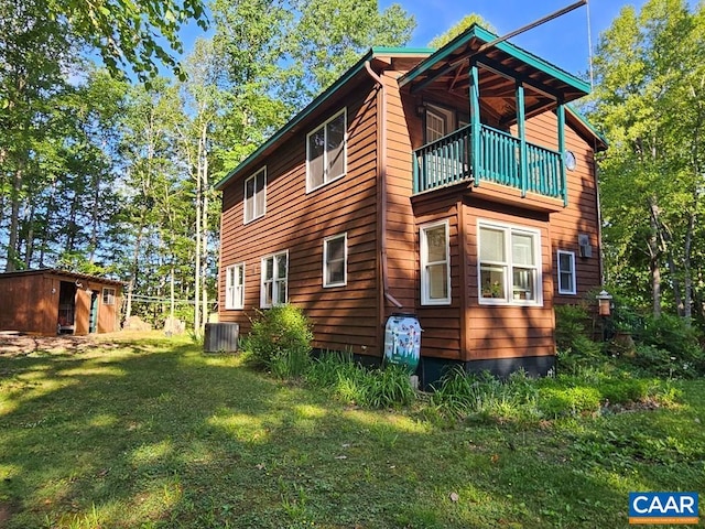 419 Camden St, Dillwyn, VA 23936 - view of property exterior with a balcony, a yard, an outbuilding, and cooling unit