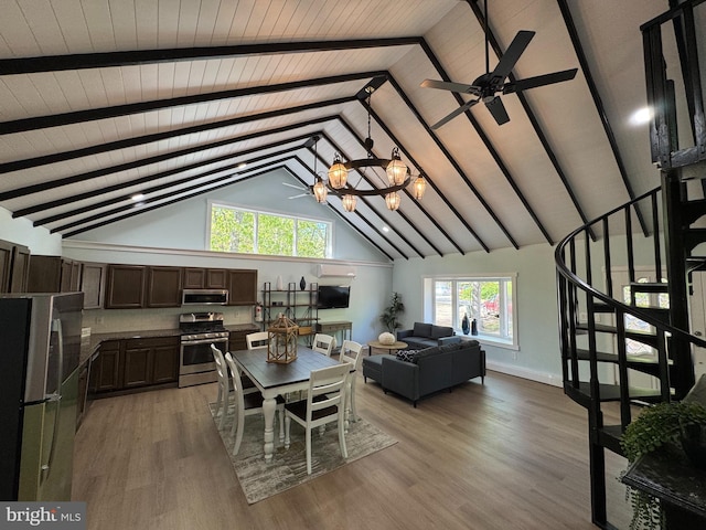 dining room with beamed ceiling, light wood-style flooring, a chandelier, stairway, and baseboards