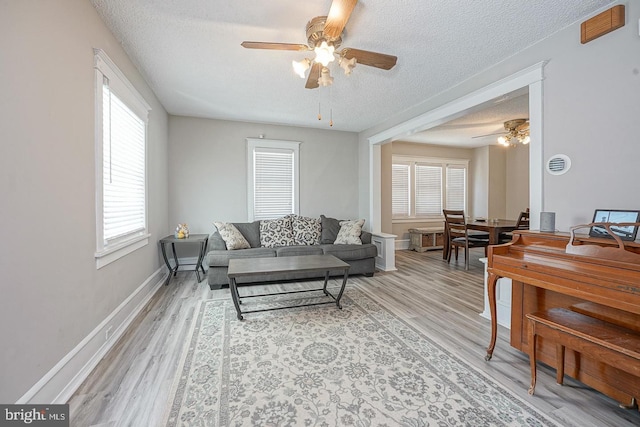 1117 Tatum St, Woodbury, NJ 08096 - living area with a ceiling fan, a textured ceiling, light wood-style floors, and baseboards