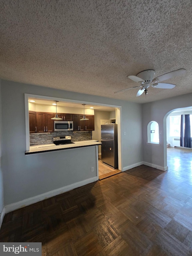 3318 Oakmont St, Philadelphia, PA 19136 - kitchen with stainless steel appliances, backsplash, light countertops, baseboards, and a textured ceiling