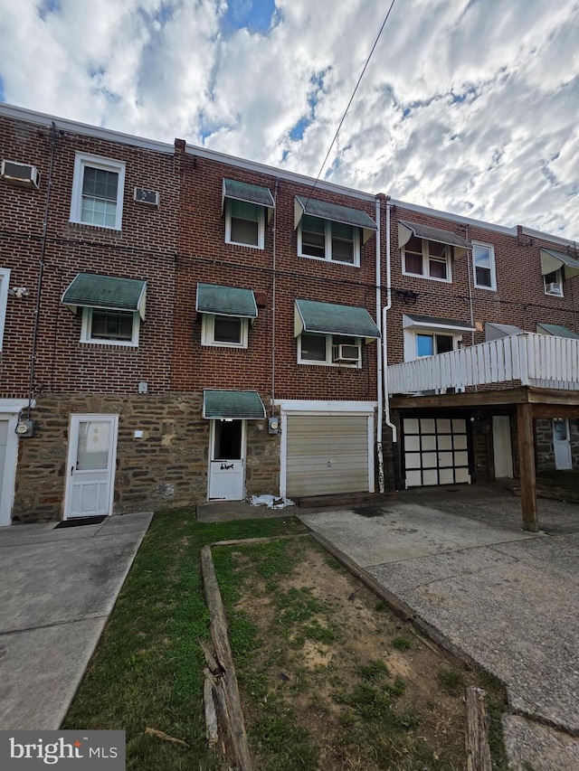 3318 Oakmont St, Philadelphia, PA 19136 - view of front of house featuring driveway, stone siding, and a garage