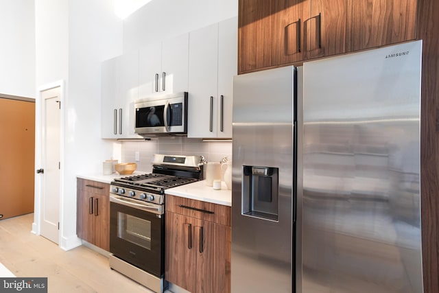 845 19th St NE Unit Ph9, Washington, DC 20002 - kitchen with stainless steel appliances, backsplash, light countertops, and modern cabinets