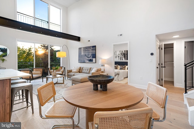845 19th St NE Unit Ph9, Washington, DC 20002 - dining room with a high ceiling, light wood-style flooring, and baseboards