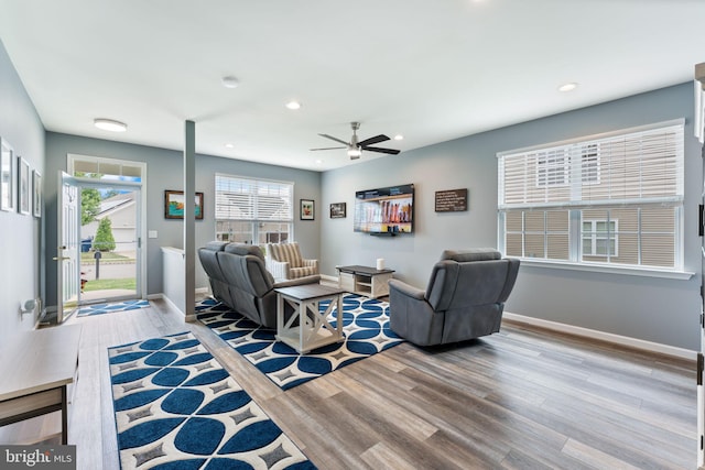 living area with wood finished floors, ceiling fan, recessed lighting, and baseboards