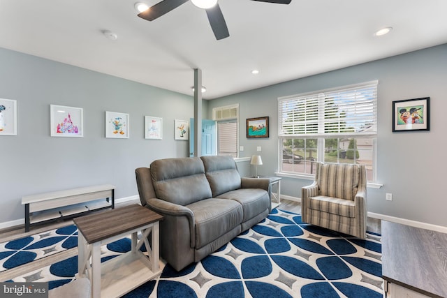 living area featuring a ceiling fan, baseboards, wood finished floors, and recessed lighting