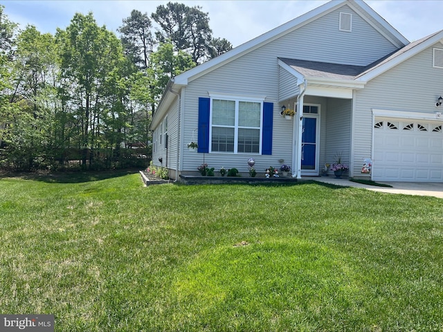 view of front of property with a front lawn and a garage