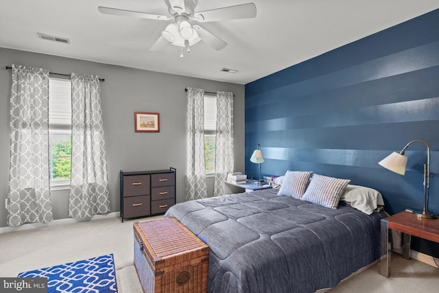 carpeted bedroom featuring ceiling fan and baseboards
