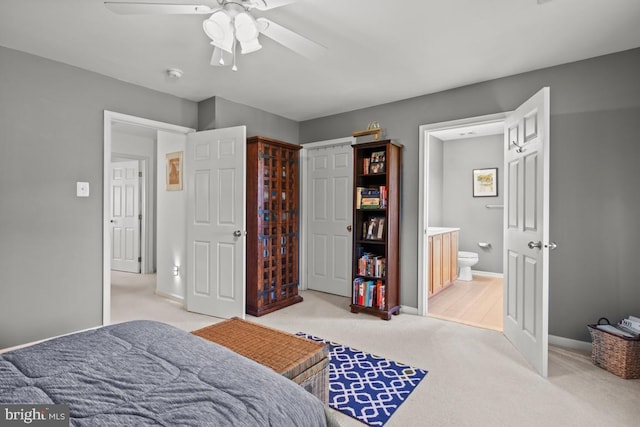 bedroom featuring carpet, baseboards, ensuite bath, and ceiling fan