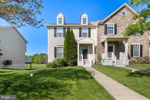view of front facade featuring stone siding and a front lawn