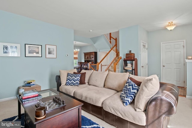 carpeted living room with a chandelier, stairs, and baseboards