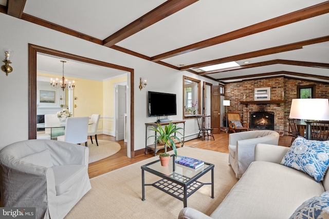 3709 Shepherd St, Chevy Chase, MD 20815 - living room featuring light wood-style flooring, a chandelier, a brick fireplace, beamed ceiling, and baseboards