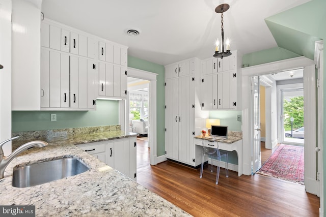 3709 Shepherd St, Chevy Chase, MD 20815 - kitchen with a sink, wood finished floors, plenty of natural light, white cabinets, and vaulted ceiling