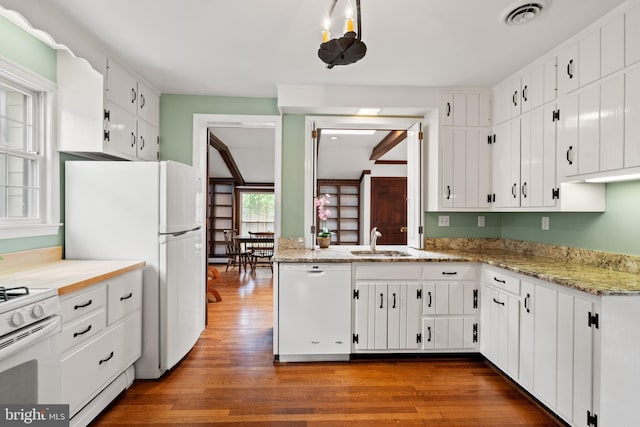 3709 Shepherd St, Chevy Chase, MD 20815 - kitchen with white appliances, a sink, dark wood-type flooring, white cabinets, and light stone counters