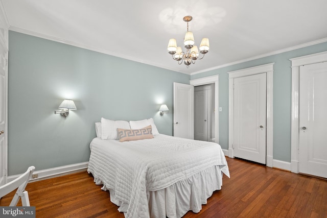 3709 Shepherd St, Chevy Chase, MD 20815 - bedroom with a chandelier, baseboards, wood finished floors, ornamental molding, and two closets
