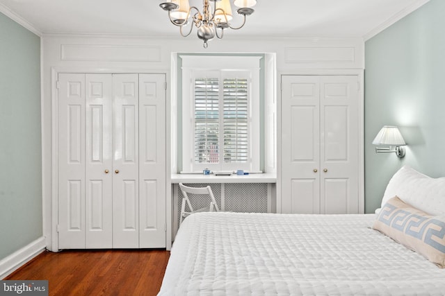 3709 Shepherd St, Chevy Chase, MD 20815 - bedroom with crown molding, a chandelier, dark wood finished floors, baseboards, and a closet