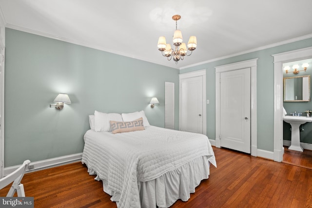 3709 Shepherd St, Chevy Chase, MD 20815 - bedroom featuring a chandelier, wood finished floors, baseboards, multiple closets, and ornamental molding
