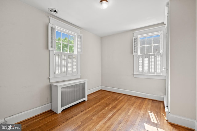 3709 Shepherd St, Chevy Chase, MD 20815 - empty room with radiator, light wood-style floors, and baseboards
