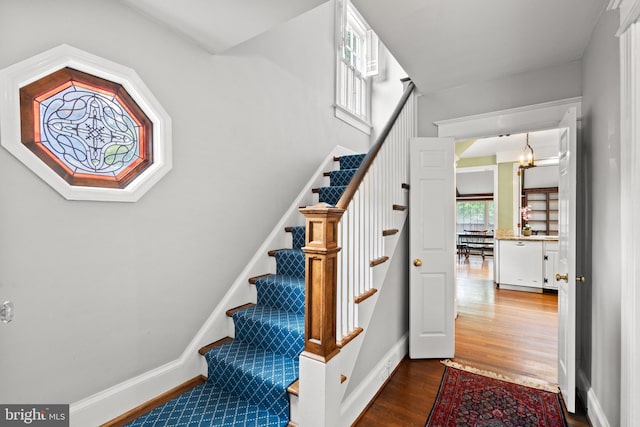 3709 Shepherd St, Chevy Chase, MD 20815 - staircase with wood finished floors, baseboards, and a chandelier