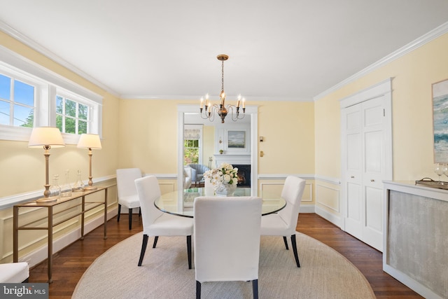 3709 Shepherd St, Chevy Chase, MD 20815 - dining area featuring a chandelier, dark wood-style flooring, crown molding, a wainscoted wall, and a decorative wall