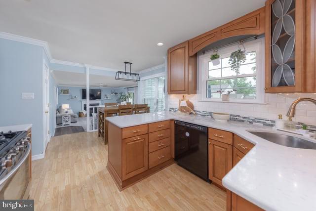 25 Aberdeen Dr, Sicklerville, NJ 08081 - kitchen featuring black dishwasher, a sink, stove, light wood-style flooring, and a peninsula