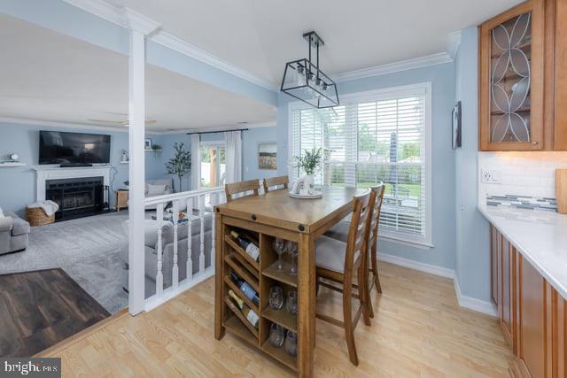 25 Aberdeen Dr, Sicklerville, NJ 08081 - dining space featuring crown molding, light wood finished floors, baseboards, a fireplace, and ceiling fan