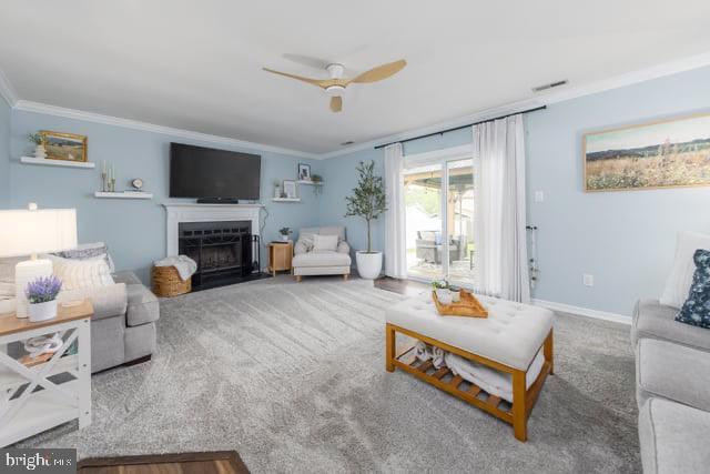25 Aberdeen Dr, Sicklerville, NJ 08081 - living room with ornamental molding, ceiling fan, a fireplace with flush hearth, carpet, and baseboards
