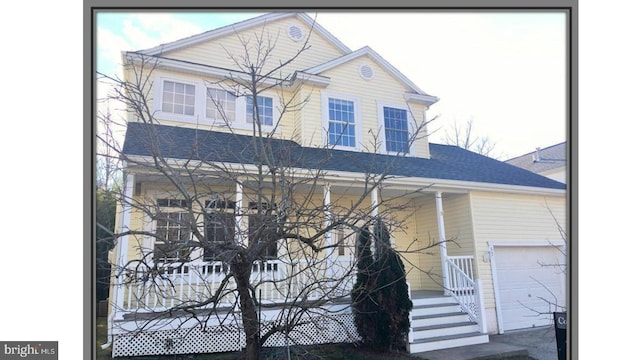 view of front of house with a porch and a garage