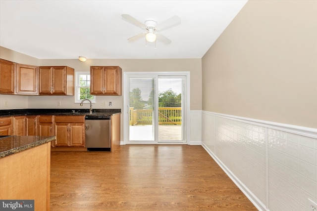 11005 Horseshoe Dr, Frederick, MD 21701 - kitchen featuring dishwasher, light wood finished floors, a ceiling fan, dark stone countertops, and brown cabinetry