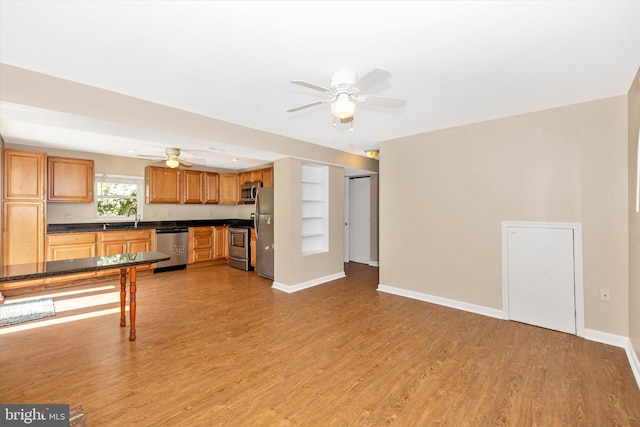 11005 Horseshoe Dr, Frederick, MD 21701 - unfurnished living room featuring a sink, a ceiling fan, light wood-style floors, and baseboards